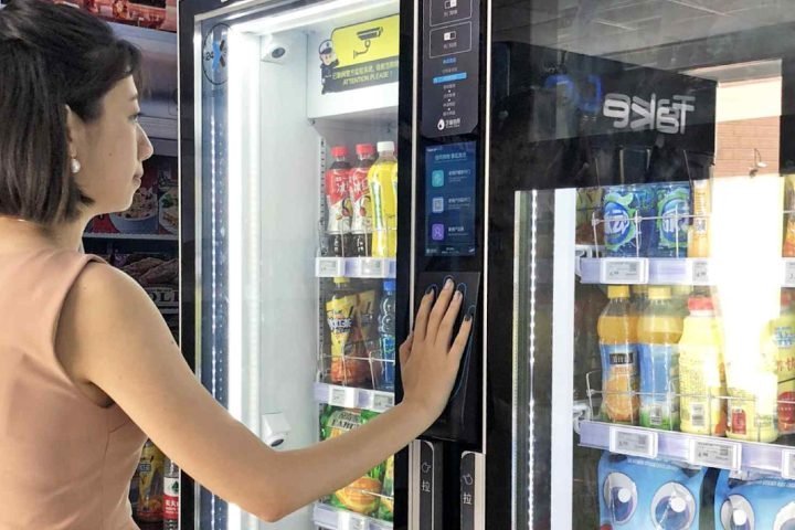 Touchscreen vending machine used by a customer Touchscreen vending machine used by a customer